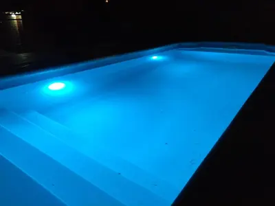 a pool with blue lights on top of it at Cabaña en el centro La Casona in Mina Clavero
