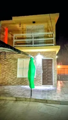 a green object in front of a building at night at Fidelita in Villa Carlos Paz