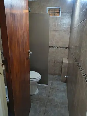 a bathroom with a toilet and a shower at Fidelita in Villa Carlos Paz
