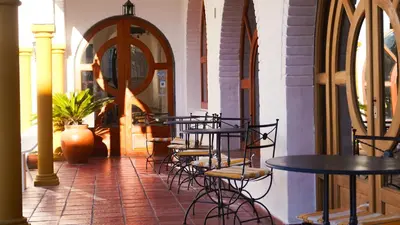 a row of tables and chairs in a building at Hotel Maspalomas in Villa Carlos Paz