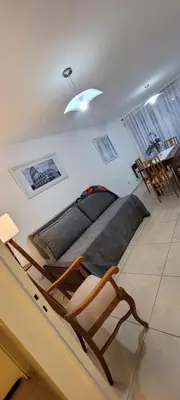 a bedroom with a bed and a chair in a room at Departamento Pilay Futura Seguridad las 24 horas in Cordoba