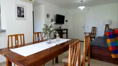 a dining room table with a vase of flowers on it at Departamento Pilay Futura Seguridad las 24 horas in Cordoba