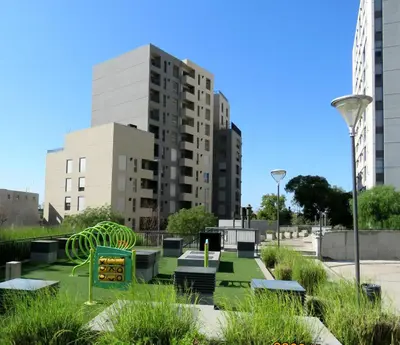 a park with benches and buildings in a city at Departamento Pilay Futura Seguridad las 24 horas in Cordoba