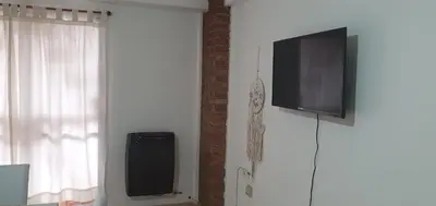 a flat screen tv on a wall next to a window at Departamento Urquiza2 in Alta Gracia