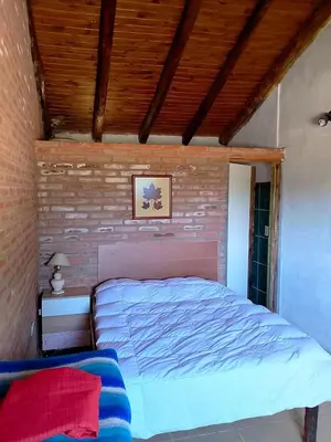 a bed in a room with a brick wall at La Serranita in Panaholma