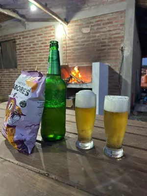 two glasses of beer and a bag of chips on a table at La Serranita in Panaholma