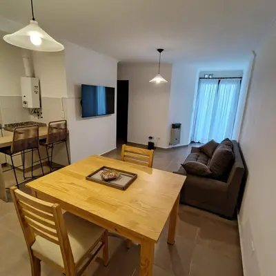 a living room with a table and a couch at 25 de Mayo Clínicas cerca in Cordoba