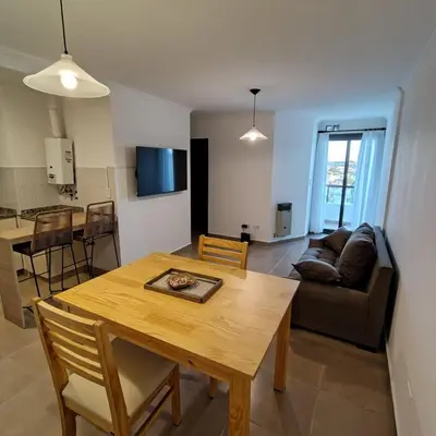 a living room with a table and a couch at 25 de Mayo Clínicas cerca in Cordoba