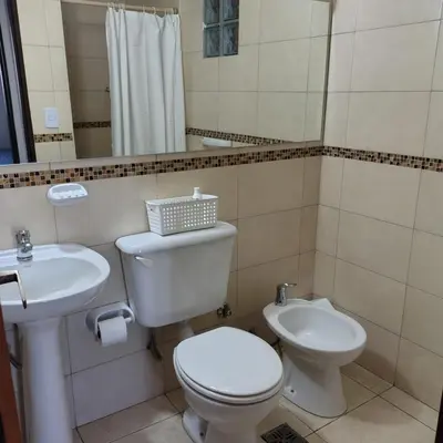 a bathroom with a toilet and a sink at 25 de Mayo Clínicas cerca in Cordoba