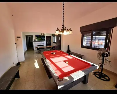 a living room with a pool table in the middle of it at Cazona Villa Carmen in Villa Carlos Paz