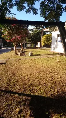 a view of a park with a tree and a bench at Cazona Villa Carmen in Villa Carlos Paz
