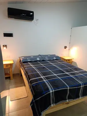 a bedroom with a bed in a room at Sinaí Apart in Santa Rosa de Calamuchita