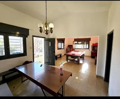 a living room with a table and a pool table at Cazona Villa Carmen2 in Villa Carlos Paz