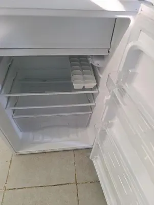 an empty refrigerator with its door open and its drawer at La morada in Cordoba