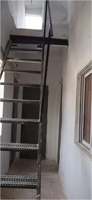 a metal staircase in a room with a window at La morada in Cordoba