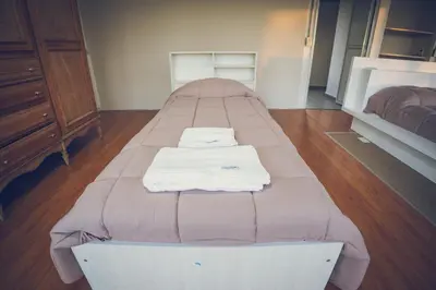 a bed with two towels on it in a room at Lo de Paul in Hernando