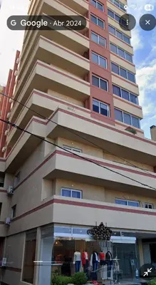 a tall building with a store in front of it at Torre del Lago X in Villa Carlos Paz