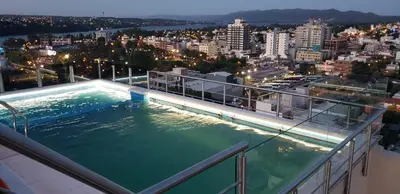 a swimming pool on the balcony of a building at Torre del Lago X in Villa Carlos Paz
