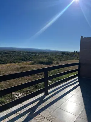 a bench on the side of a fence in a field at Villa alpina in Bialet Massé