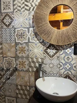 a bathroom with a sink and a mirror on a wall at Villa alpina in Bialet Massé