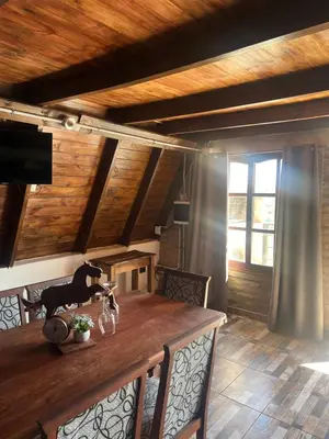 a dining room with a wooden table and chairs at Villa alpina in Bialet Massé