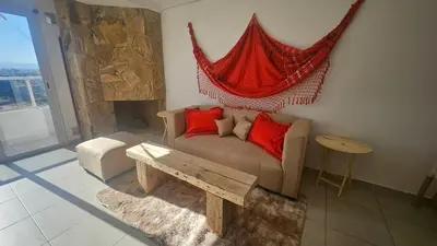 a living room with a couch with a hammock above it at Magníficas VISTAS in Cordoba