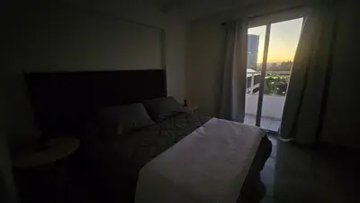 a bedroom with a bed and a large window at Magníficas VISTAS in Cordoba