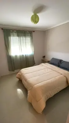 a large bed in a bedroom with a window at Departamento Barrio Cerrado Terra 2 seguridad 24h pileta in Cordoba