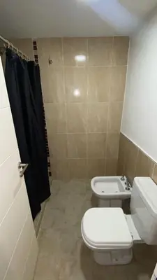 a bathroom with a toilet and a sink at Departamento Barrio Cerrado Terra 2 seguridad 24h pileta in Cordoba