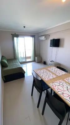 a room with two tables and a bed in it at Departamento Barrio Cerrado Terra 2 seguridad 24h pileta in Cordoba