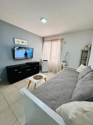 a bedroom with a bed and a flat screen tv at Departamento premium, ubicación céntrica, Patio Olmos! in Cordoba