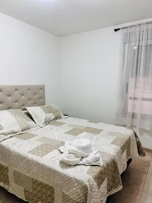 a bedroom with a bed with two towels on it at Departamento premium, ubicación céntrica, Patio Olmos! in Cordoba