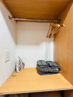 a room with a wooden shelf with towels on it at Departamento premium, ubicación céntrica, Patio Olmos! in Cordoba