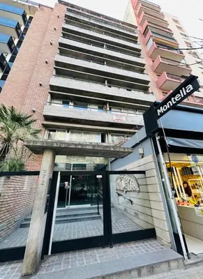 a street sign in front of a building at Departamento premium, ubicación céntrica, Patio Olmos! in Cordoba