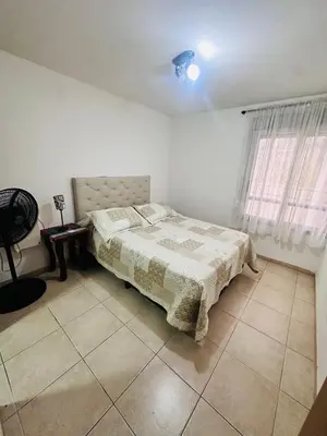 a white bedroom with a bed and a window at Departamento premium, ubicación céntrica, Patio Olmos! in Cordoba