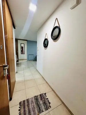 a hallway with a white wall with two mirrors on it at Departamento premium, ubicación céntrica, Patio Olmos! in Cordoba