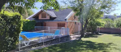 a house with a swimming pool in a yard at Cabaña Don Fernando in Los Hornillos