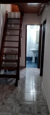 a room with a staircase and a bathroom with a sink at Cabaña Don Fernando in Los Hornillos