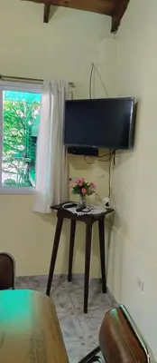 a table with flowers on it in a room at Cabaña Don Fernando in Los Hornillos