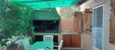 a patio with a table and chairs and a sink at Cabaña Don Fernando in Los Hornillos