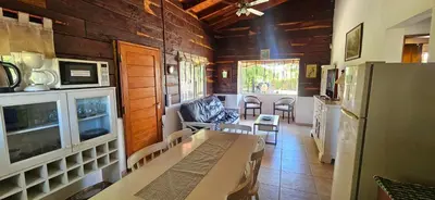a living room with a table and a refrigerator at Ribera Calma in Los Reartes