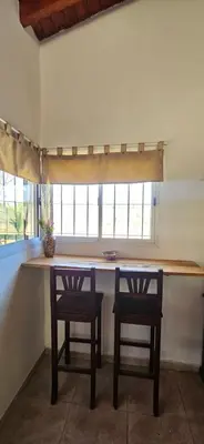 a kitchen with a table with two chairs and a window at Ribera Calma in Los Reartes