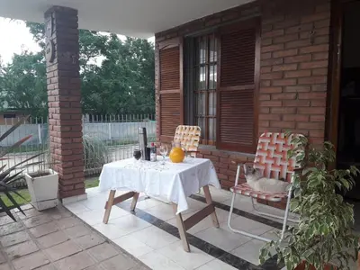 a cat sitting on a table and chairs on a patio at Rincon del sol in Villa Carlos Paz