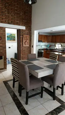 a dining room table and chairs in a kitchen at Rincon del sol in Villa Carlos Paz