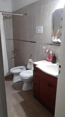 a bathroom with a toilet and a sink at Rincon del sol in Villa Carlos Paz