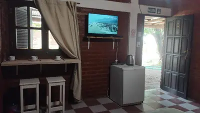 a room with a small refrigerator and a television at Suite en el corazón de Nono in Nono