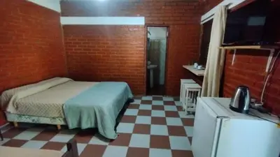 a bedroom with a bed and a tv in a room at Suite en el corazón de Nono in Nono