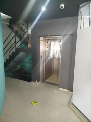 an elevator in a building with a staircase in the background at Departamento Baratti's in Villa Carlos Paz