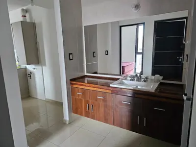 a bathroom with a sink and a mirror at Departamento Baratti's in Villa Carlos Paz
