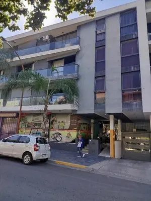 a white car parked in front of a building at Departamento Baratti's in Villa Carlos Paz
